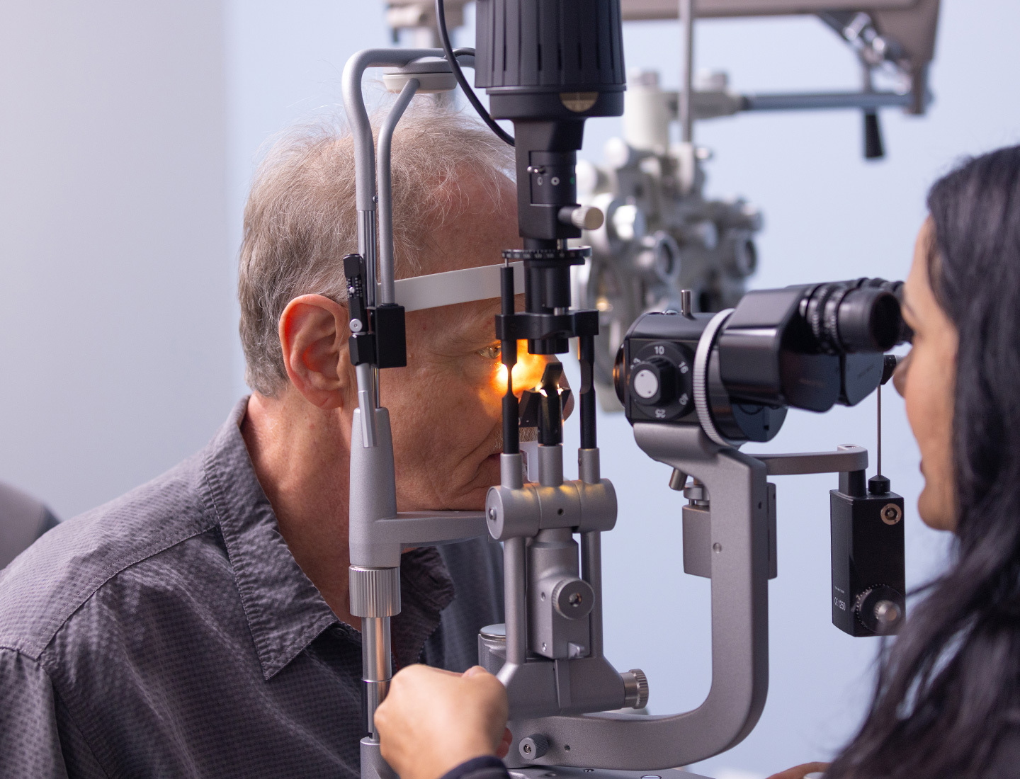 Ophthalmologist Eileen Bowden, MD, examining a patient's eyes.