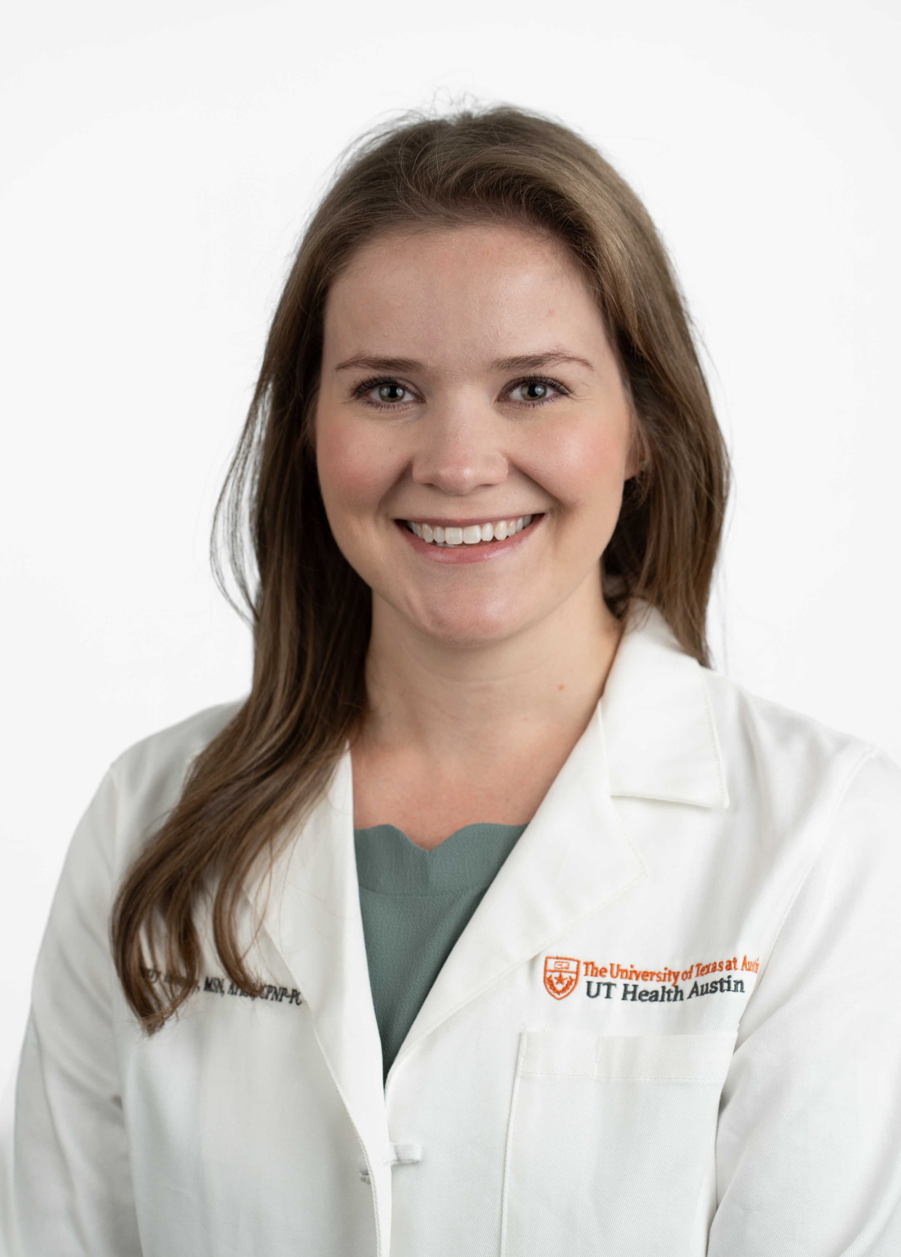 Pediatric nurse practitioner Kimberly Mooney, MSN, APRN, CPNP-PC, wearing a white coat and smiling in front of a white backdrop.