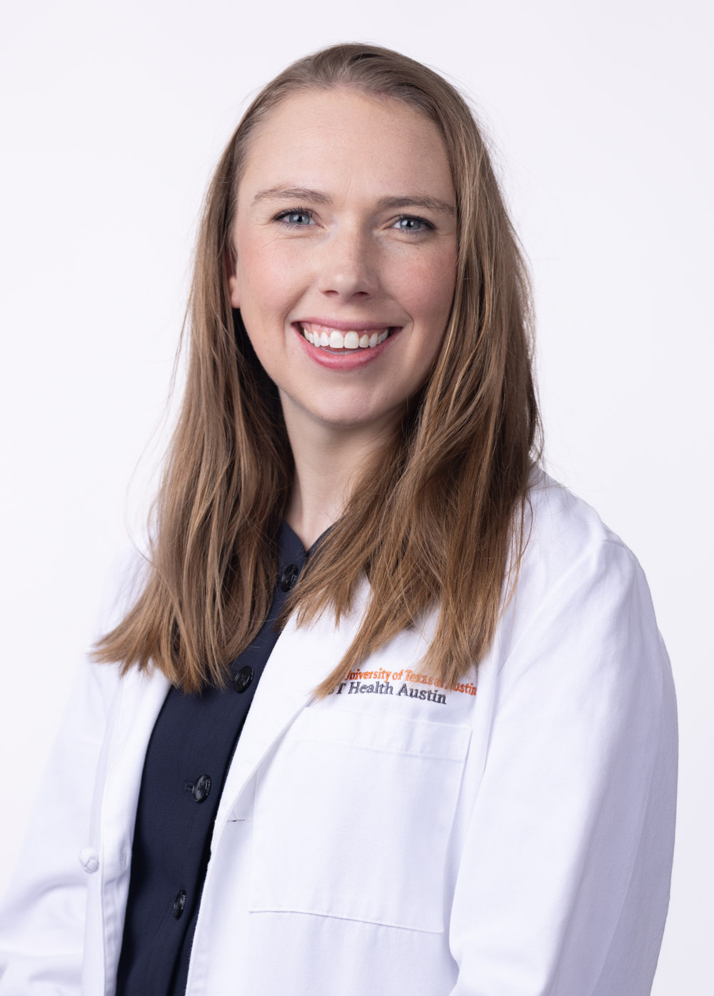 Dr. Amy Durand is wearing a white coat and black blouse. She is smiling at the camera.