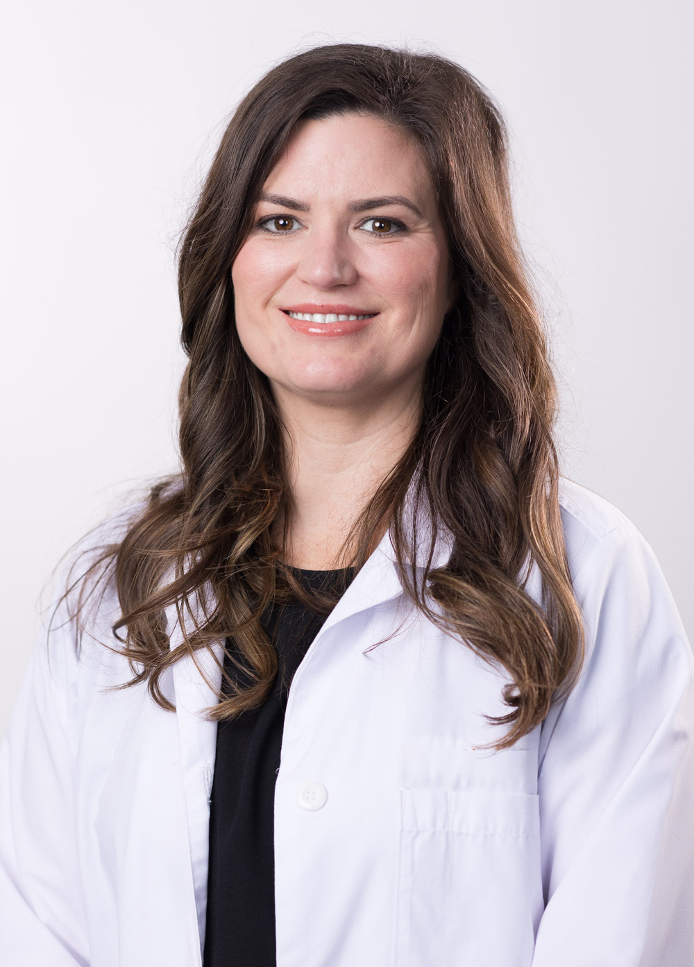 Headshot of Christina Moussette. She is wearing a black blouse and white coat.