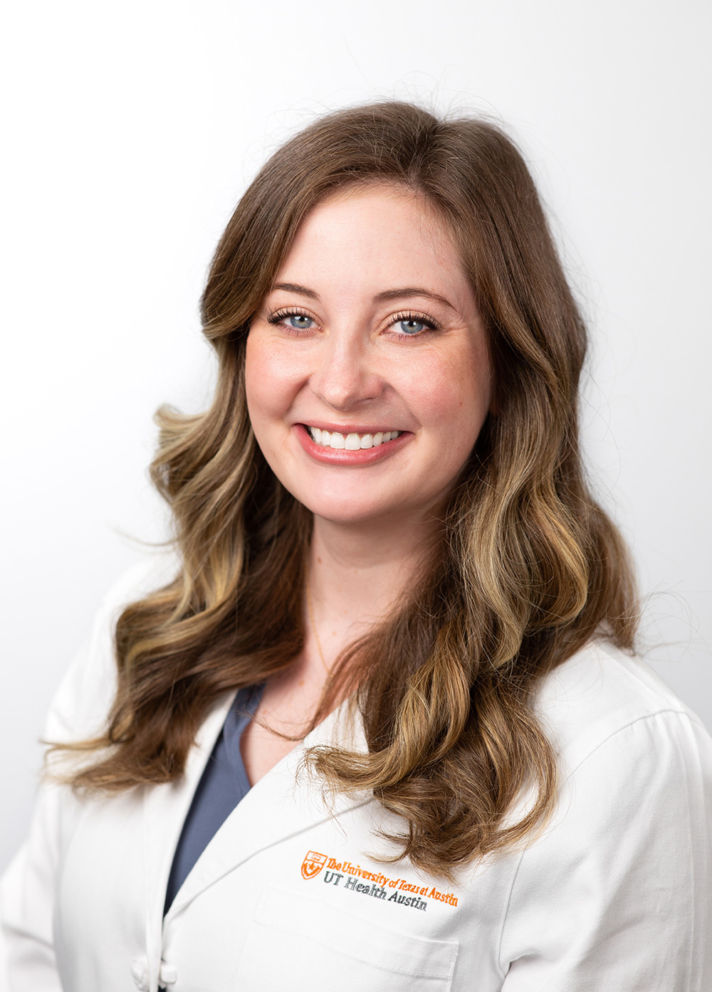 Physician assistant Erin Moise, PA-C, wearing a white coat and smiling in front of a white background.