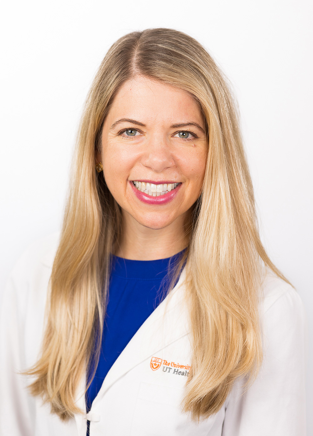 Family nurse practitioner Katherine Boos, MSN, APRN, FNP, wearing a white coat and smiling in front of a white backdrop.