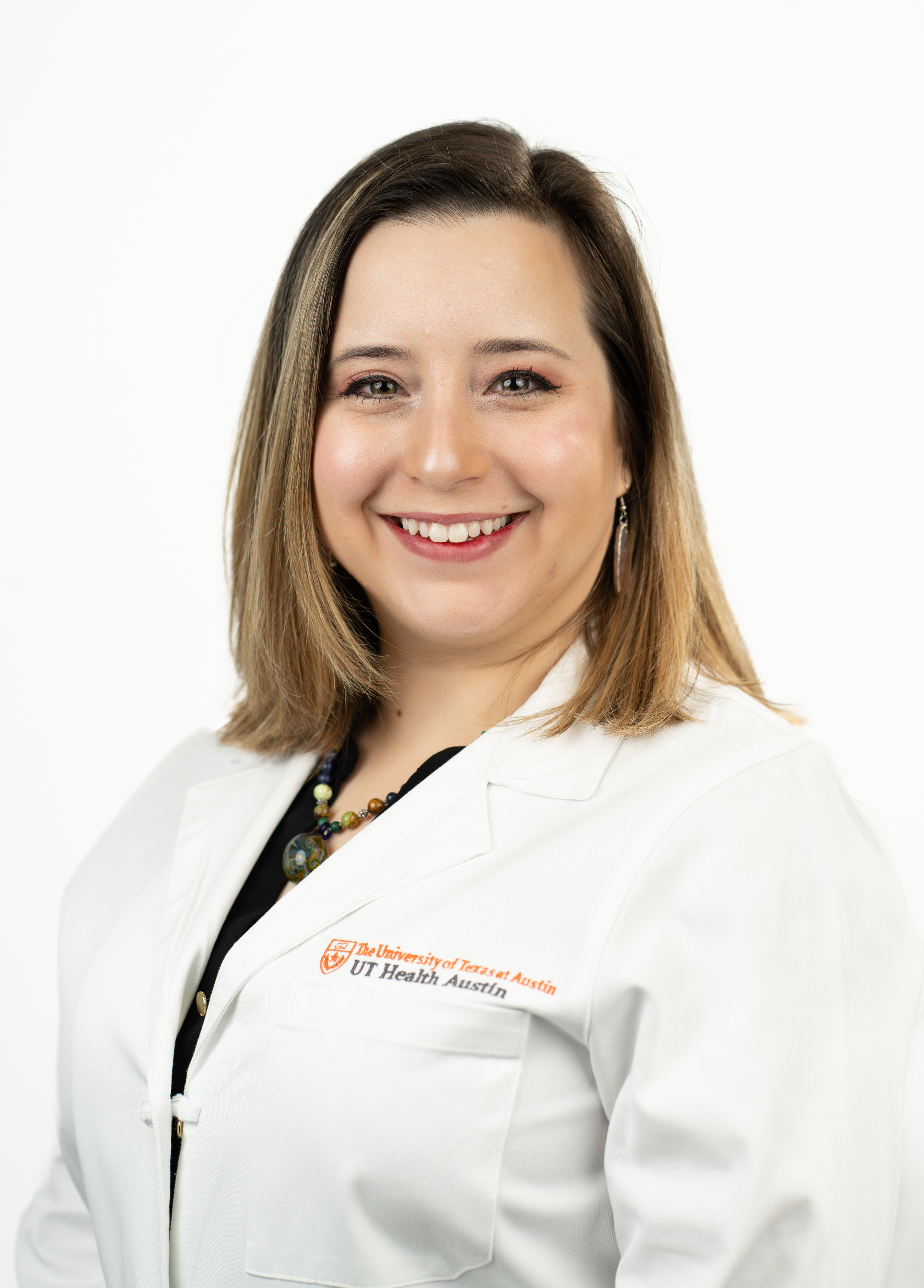 Pediatric neurologist Leah Ferrante, MD, stands in front of a white background smiling.