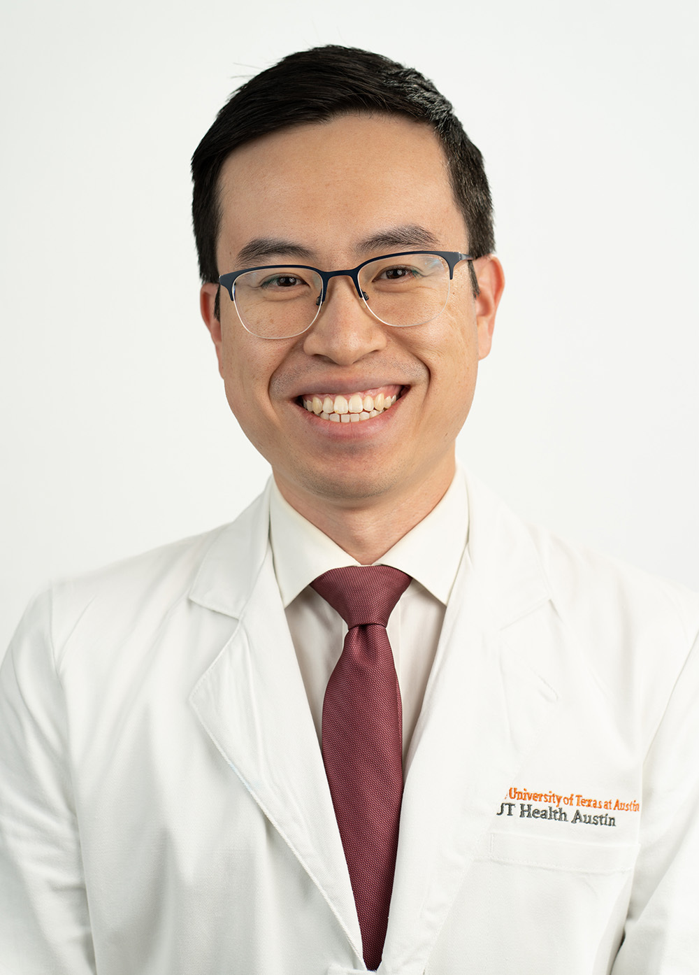 Pediatric cardiothoracic surgeon Roderick Yang, MD, wearing a white coat and smiling in front of a white background.