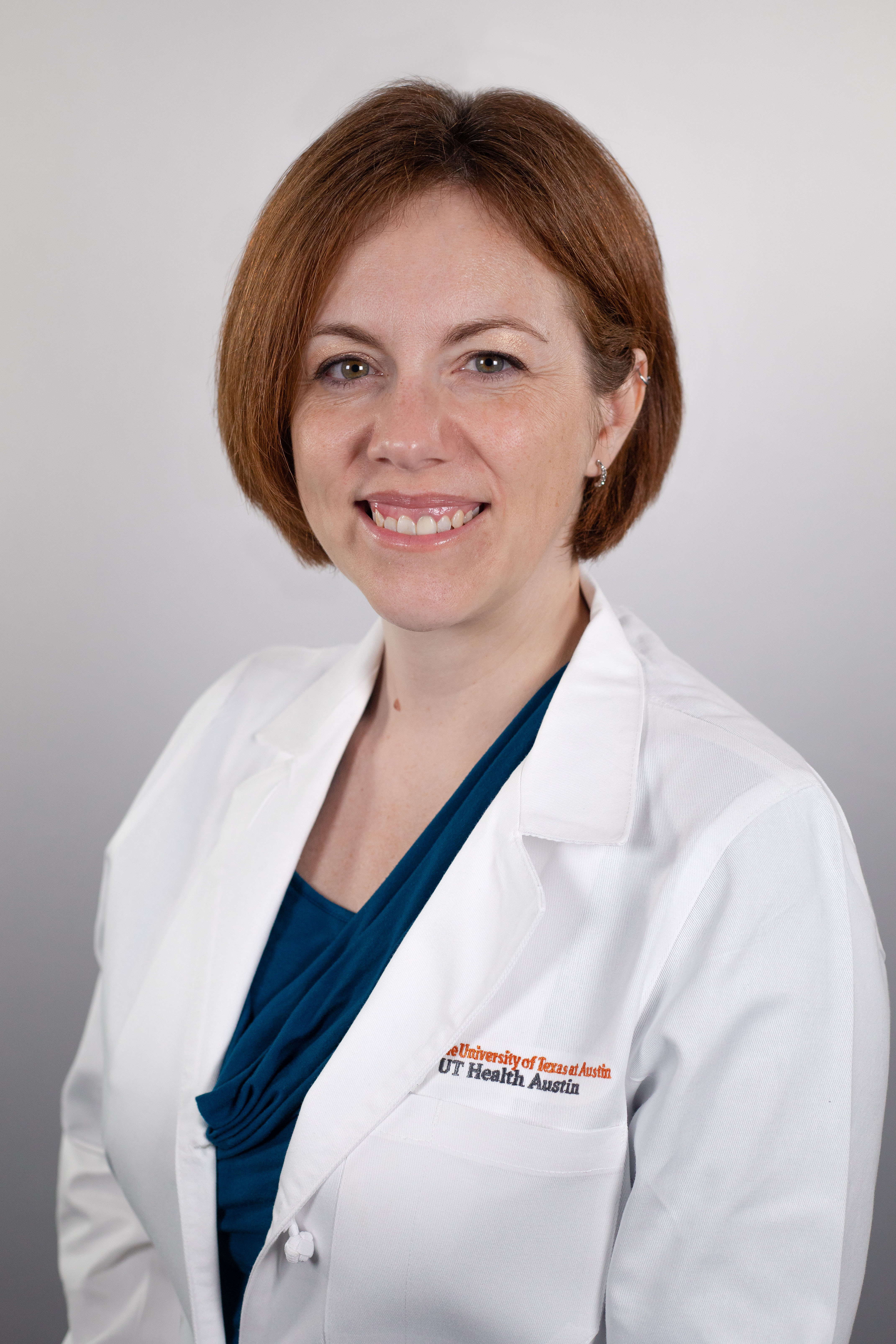 Maternal-fetal medicine specialist Lorie M. Harper, MD, MSCI, wearing a white coat and smiling in front of a white backdrop.